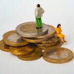 An image of coins with people sat on them.