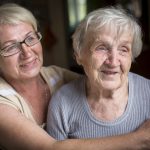 An elderly woman with her adult daughter