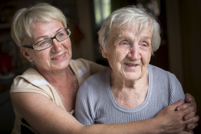 An elderly woman with her adult daughter