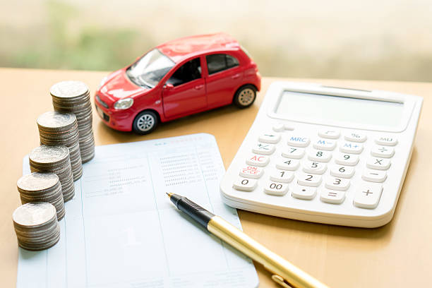 A toy car next to money and a calculator.