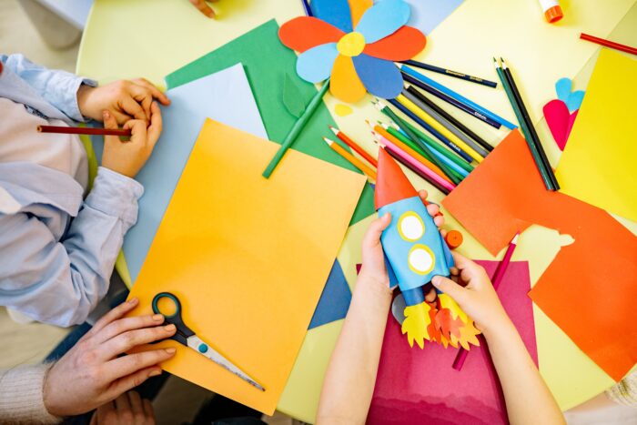 Children making rockets from craft material.