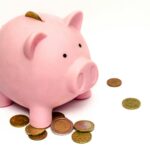 A piggy bank with scattered coins