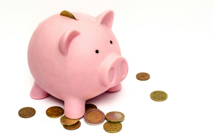 A piggy bank with scattered coins